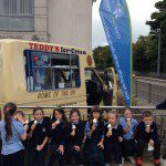 St Annes kids with ice cream 3 sitting on wall with CU flag and van name