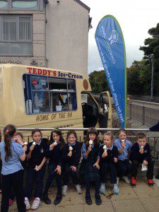 St Annes kids with ice cream 3 sitting on wall with CU flag and van name