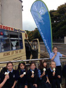 St Annes kids with ice cream 3 sitting on wall with CU flag