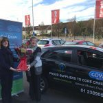 Maura Duffy with Liz Harper Banner and Flowers and car 1