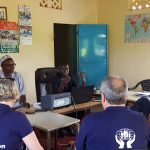 Caption 2. Abdoulie Sanneh, Manager, Fankanta Cooperative Credit Union discussing his credit union with the volunteers.